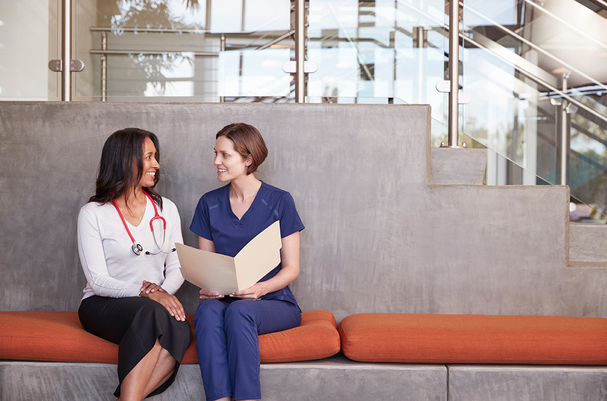 two-female-healthcare-workers-discussing-a-medical-SF9RJN8-1.jpg